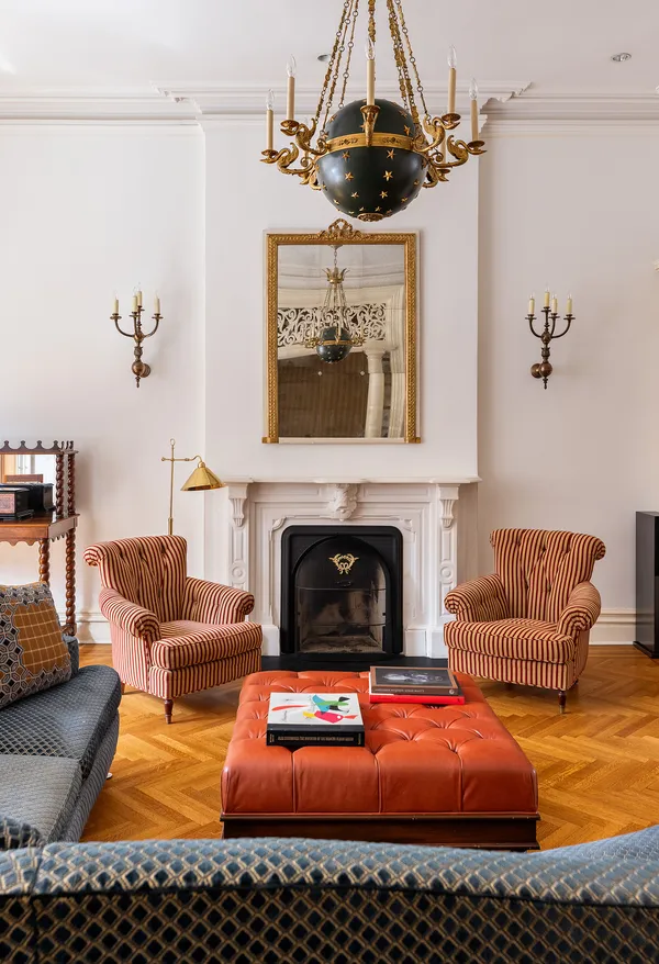 a living room with furniture a large window and a fireplace