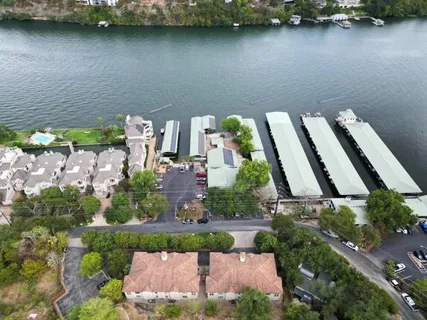an aerial view of a house with a yard and lake view