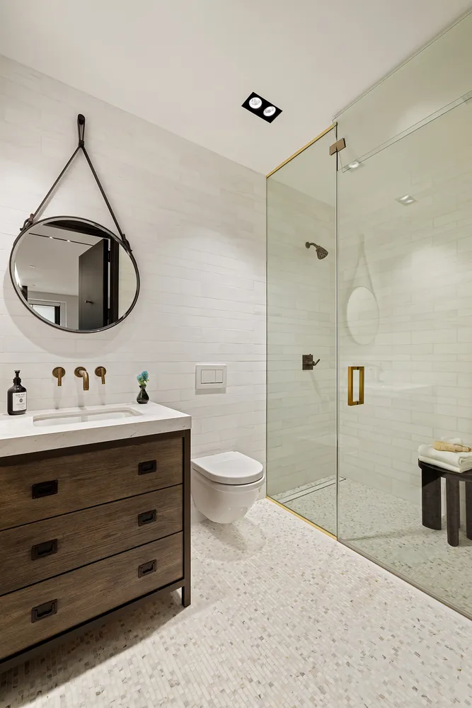 a bathroom with a toilet sink and shower