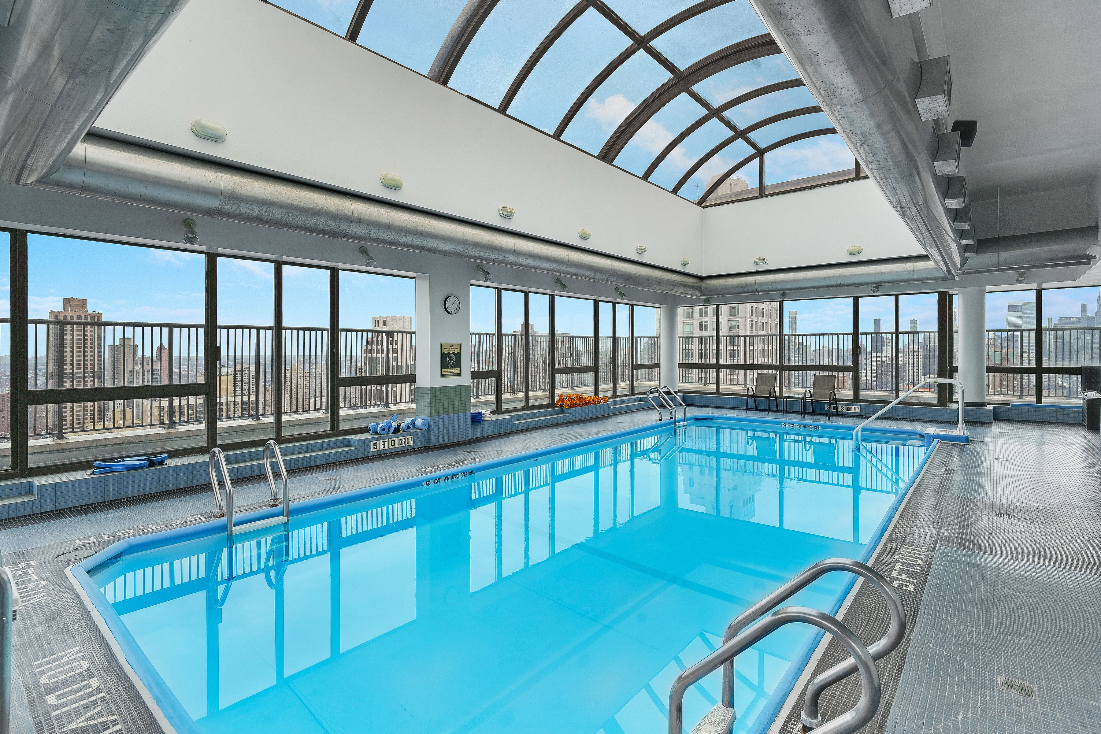 171 East 84th Street, Unit 22C Manhattan, NY 10028 - Photo 13 of 17 a kitchen with stainless steel appliances granite countertop a sink and cabinets