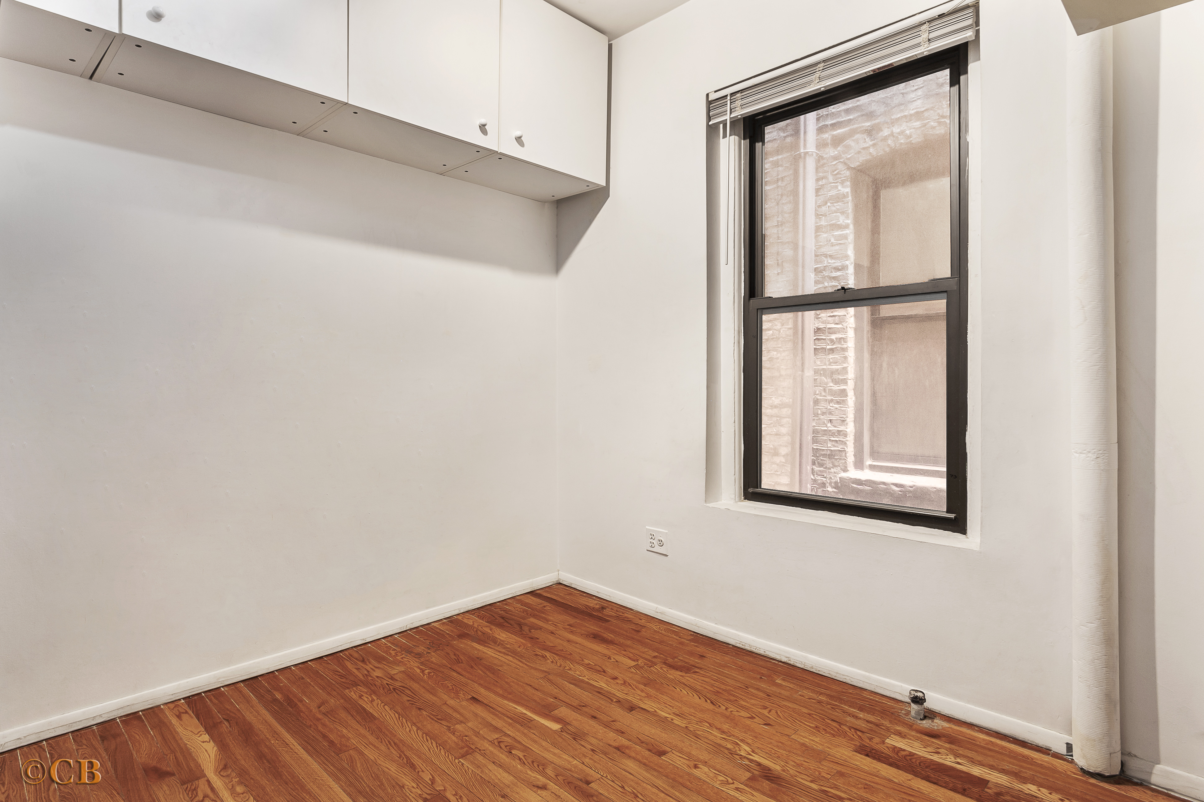 131 Thompson Street, Unit 4C Manhattan, NY 10012 - Photo 8 of 9 a view of a room that has a window in it