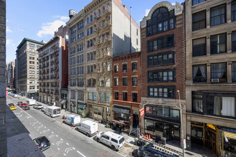 a city street filled with lots of tall buildings