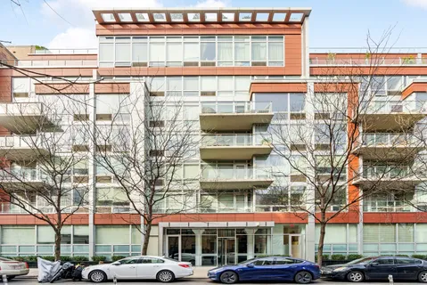 a front view of a building with parking area