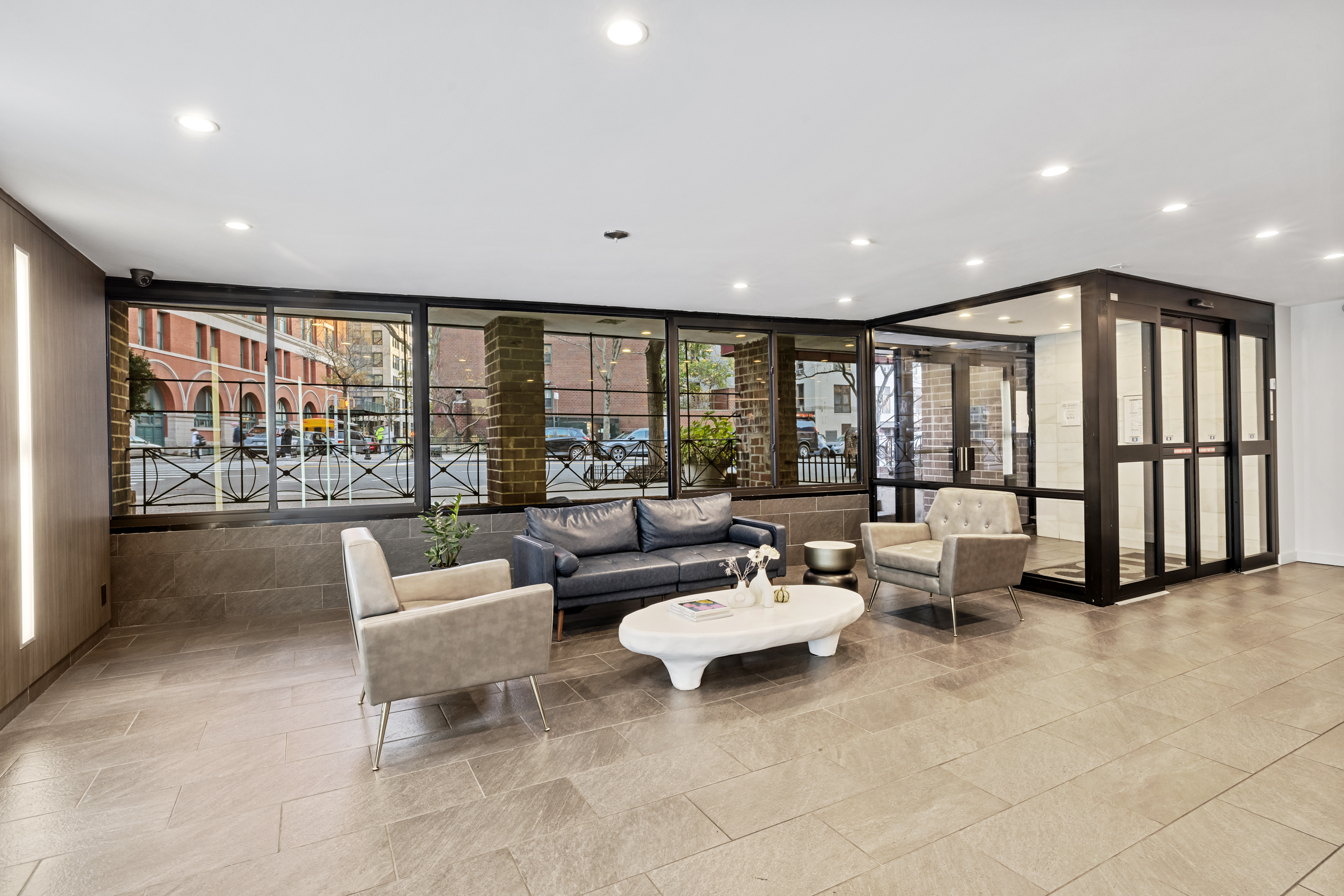 165 Christopher Street, Unit 3I Manhattan, NY 10014 - Photo 13 of 20 a living room with furniture and a large window