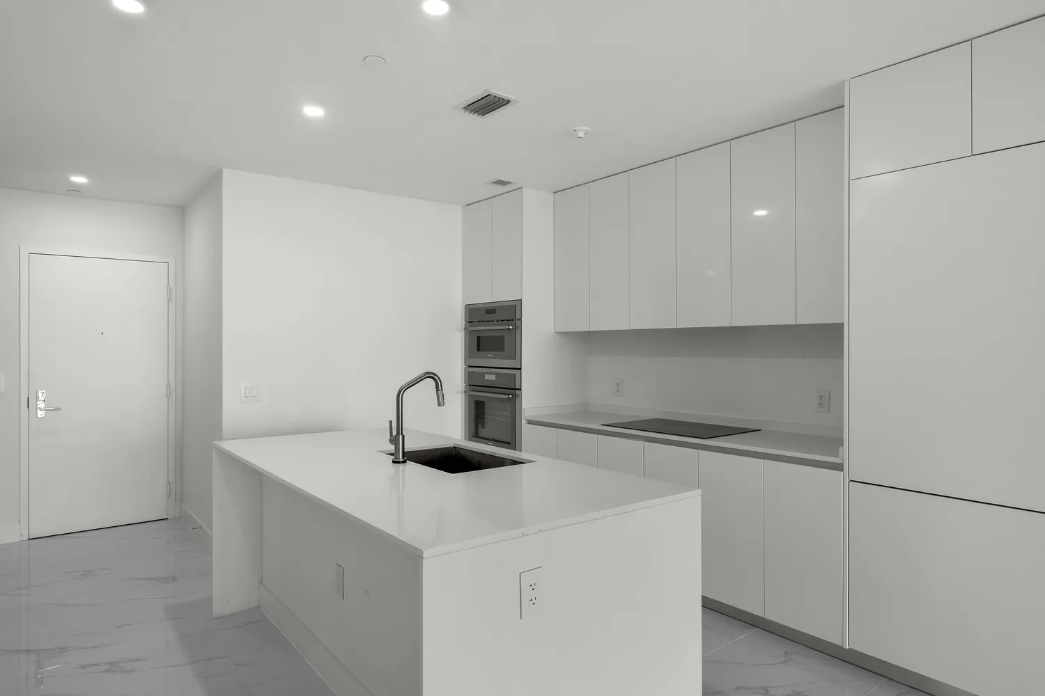 a kitchen with a sink a stove and cabinets
