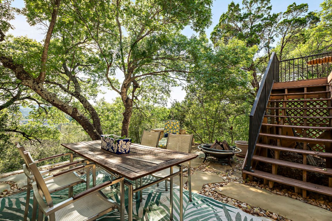 1607 The High Road Austin, TX 78746 - Photo 13 of 28 a backyard of a house with table and chairs