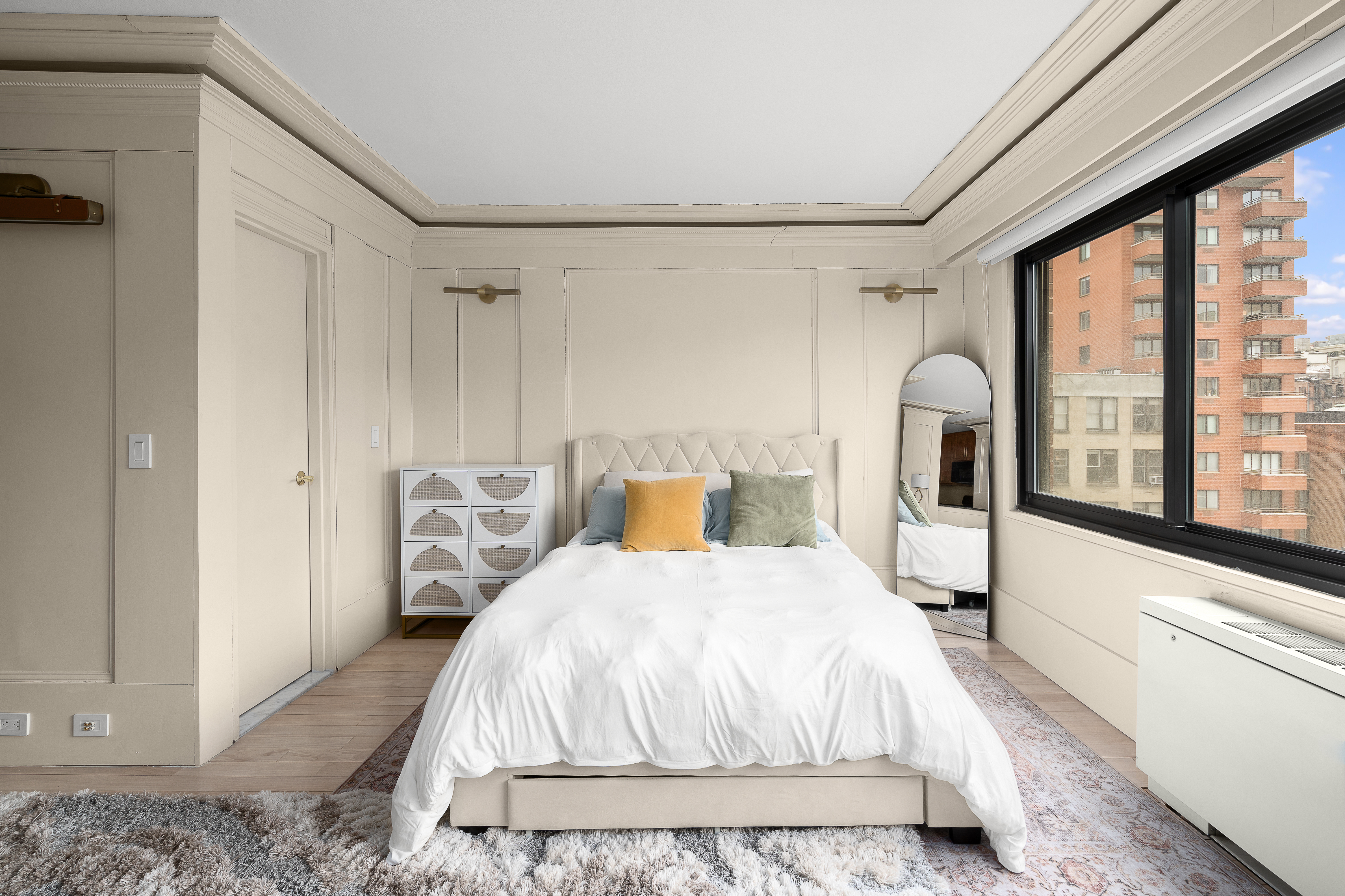 201 West 21st Street, Unit 8G Manhattan, NY 10011 - Photo 3 of 8 a bedroom with a bed and a large window