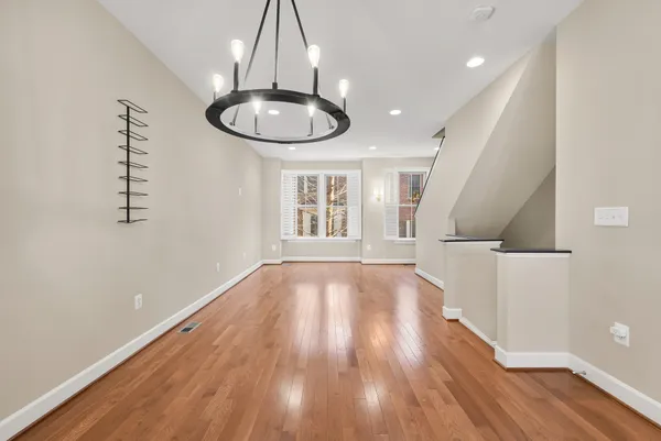 a view of a room with wooden floor and window
