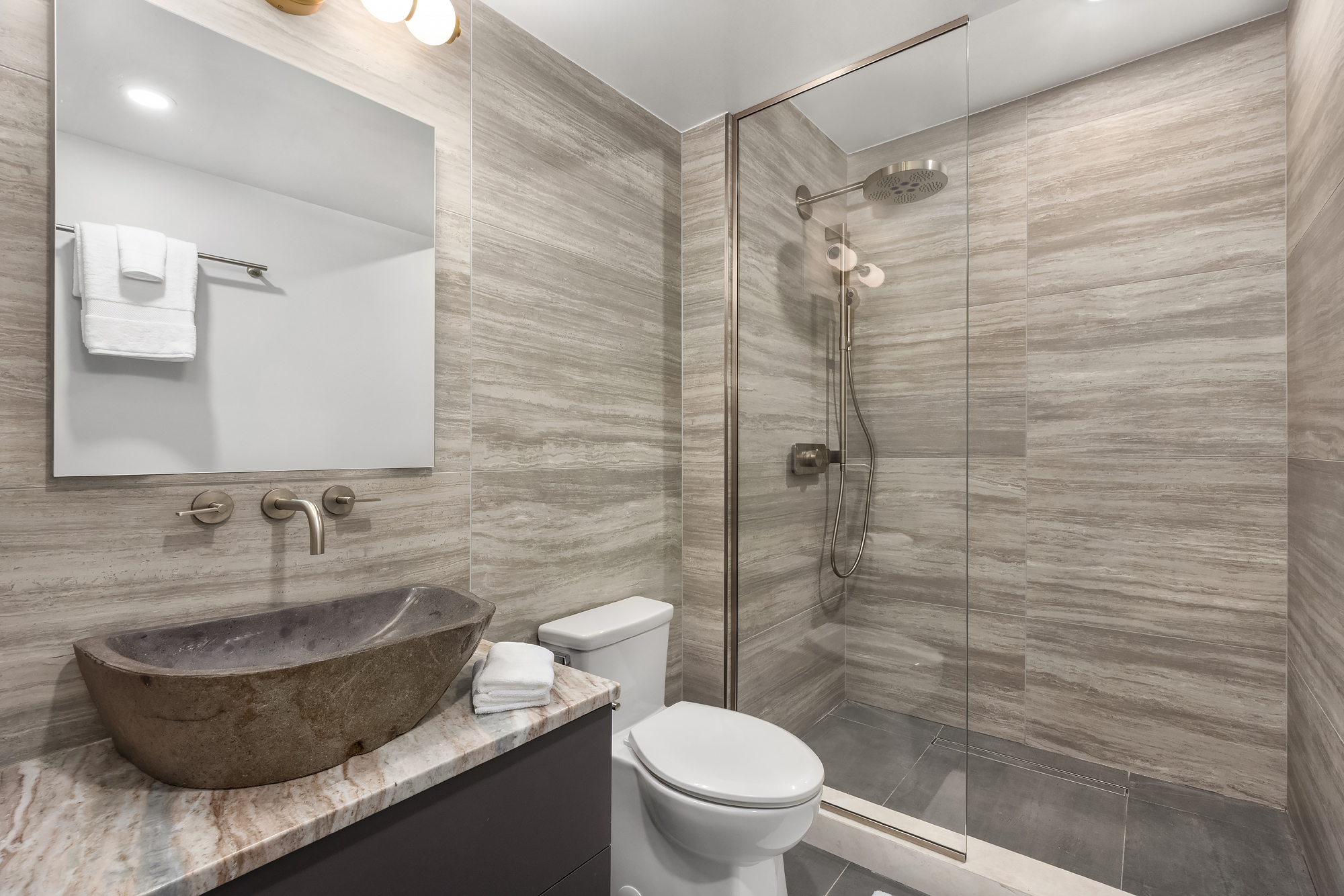 53 West 85th Street Manhattan, NY 10024 - Photo 31 of 37 a bathroom with a granite countertop toilet sink and shower