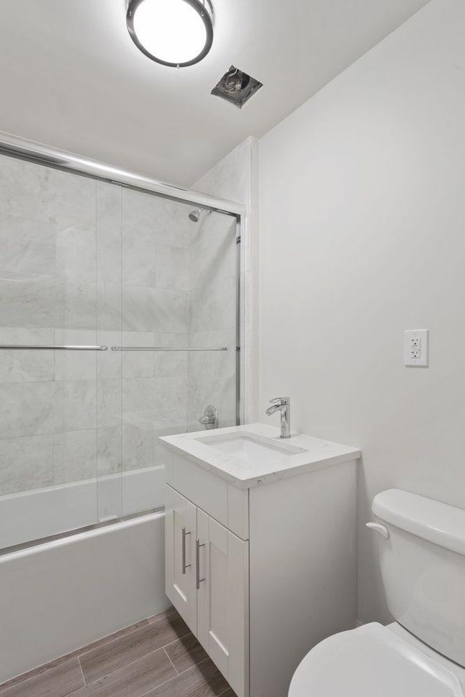 187 Woodpoint Road Brooklyn, NY 11211 - Photo 14 of 17 a bathroom with a sink a toilet and shower