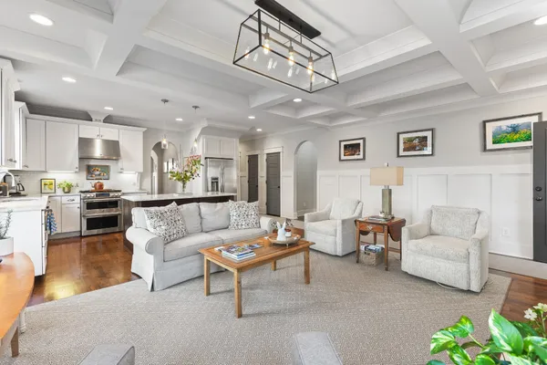 a living room with furniture and kitchen view