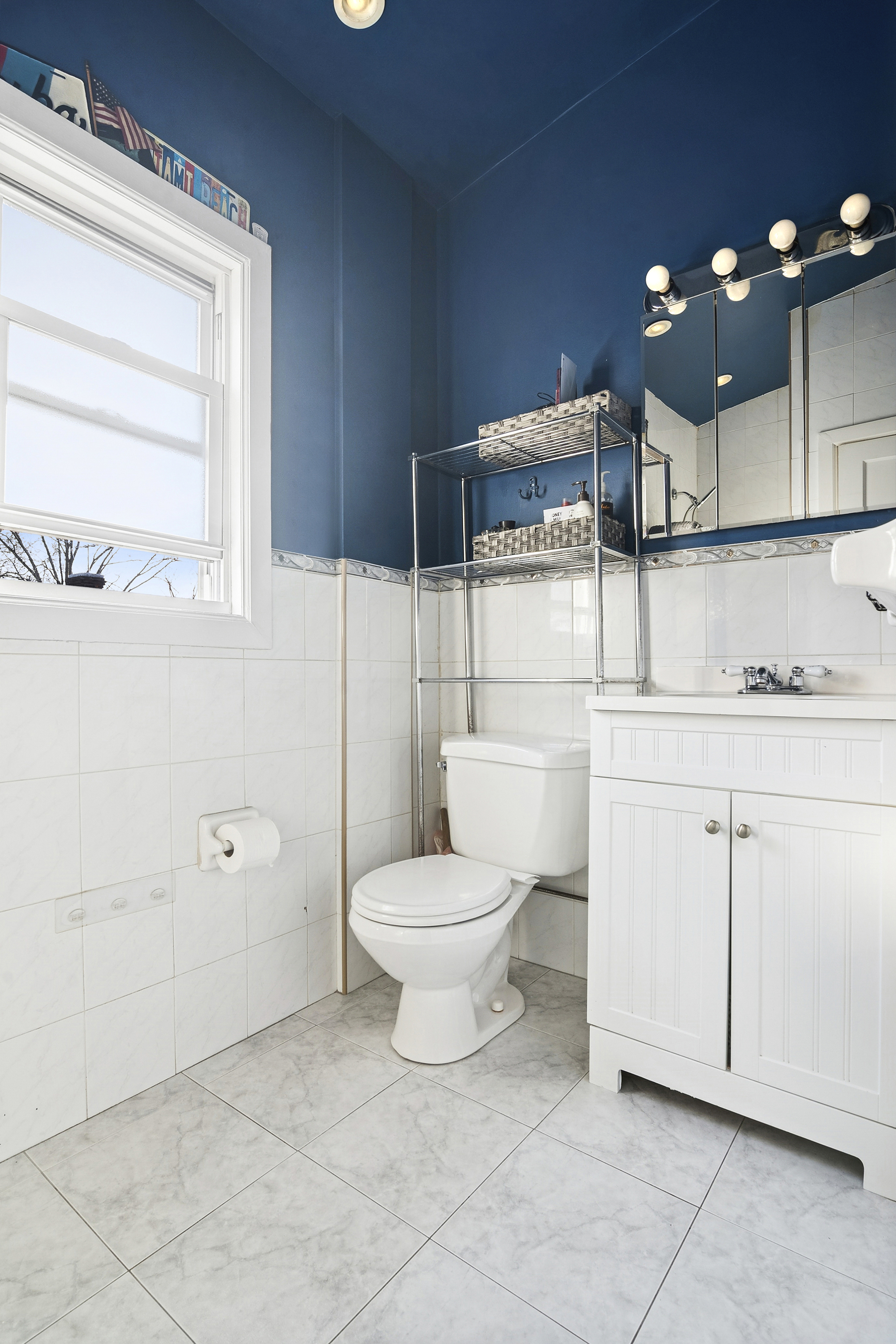 1384 East 29th Street Brooklyn, NY 11210 - Photo 12 of 21 a bathroom with a toilet sink and mirror