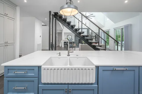 a kitchen with granite countertop a sink stove and cabinets