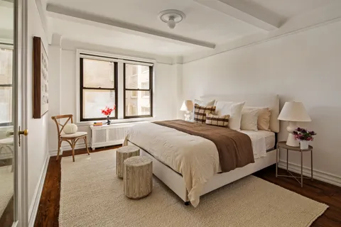 a bed room with a bed and a chair