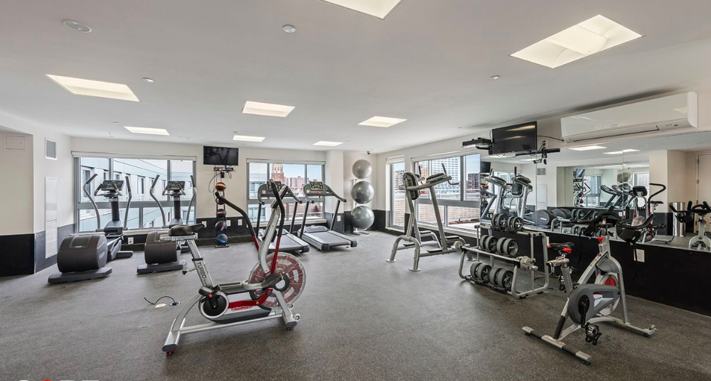 171 West 131st Street, Unit 519 Manhattan, NY 10027 - Photo 7 of 10 a view of a room with gym equipment