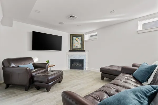 a living room with furniture a flat screen tv and a fireplace