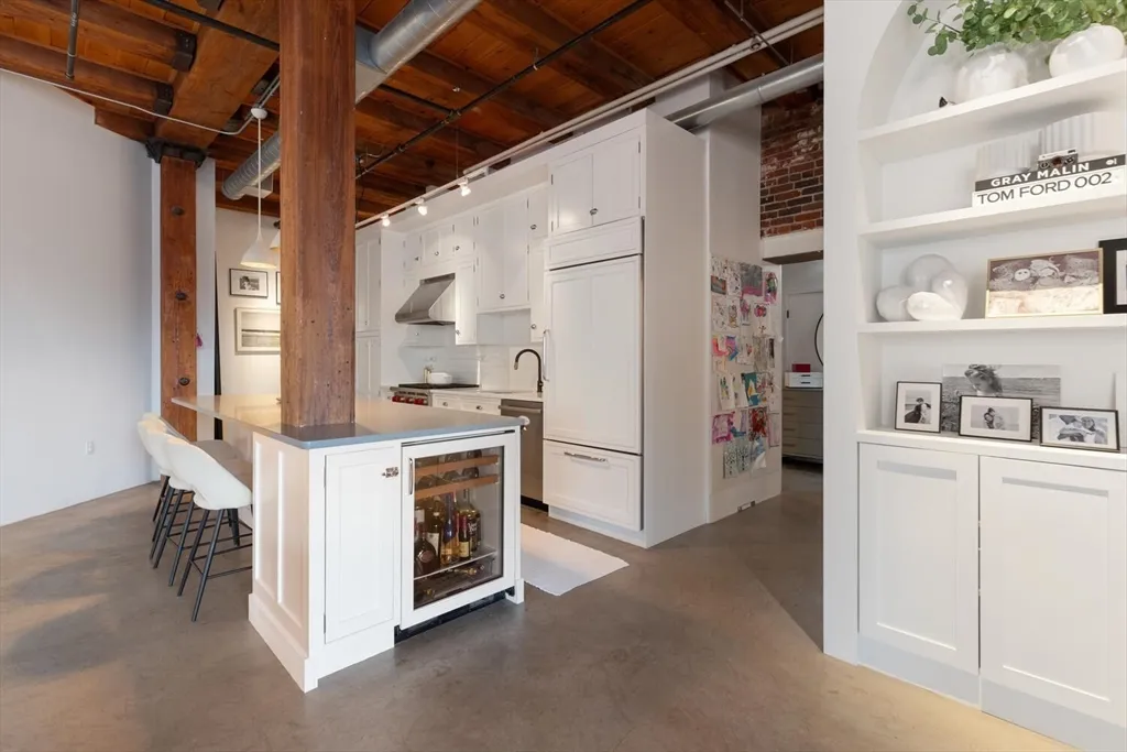 a utility room with cabinets washer and dryer