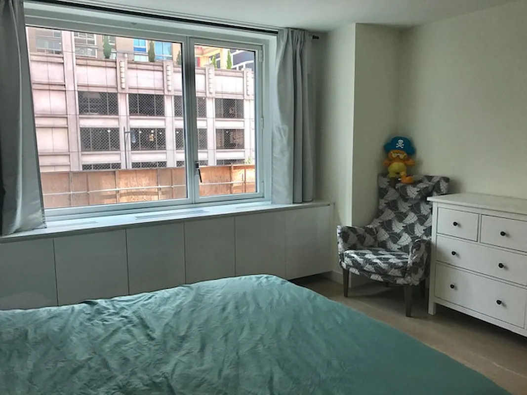 301 West 53rd Street, Unit 3I Manhattan, NY 10019 - Photo 5 of 14 a bedroom with a bed and a window