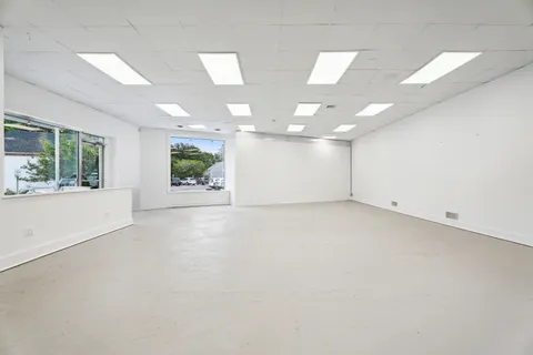 an empty room with windows and entrance