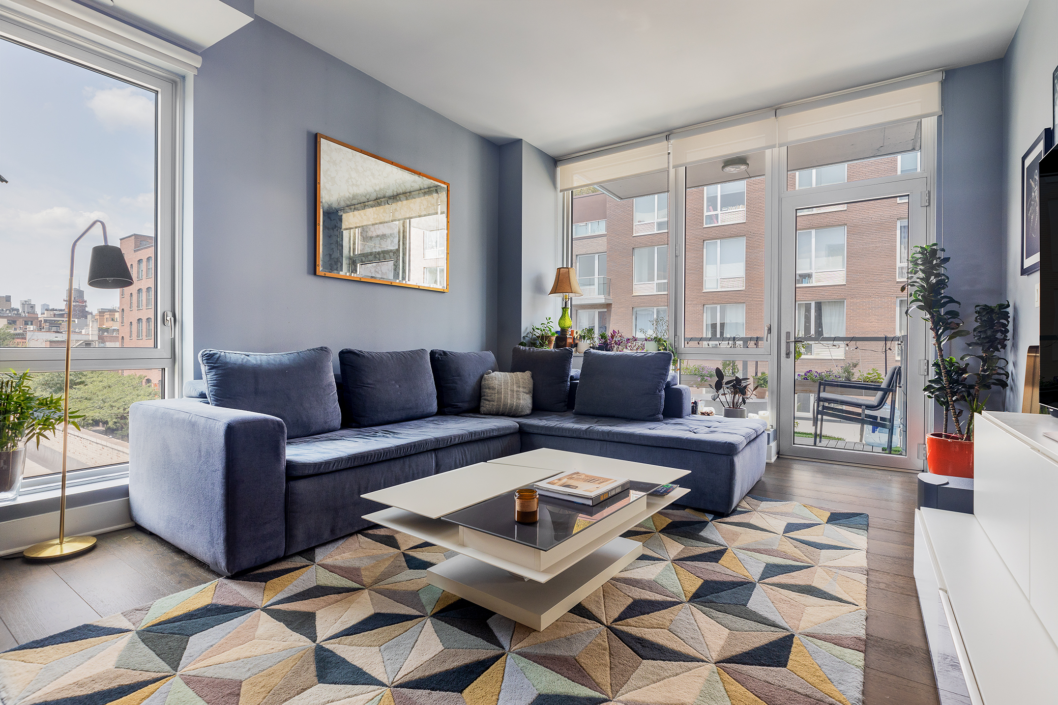 212 North 9th Street, Unit 5D Brooklyn, NY 11211 - Photo 1 of 13 a living room with furniture and a floor to ceiling window