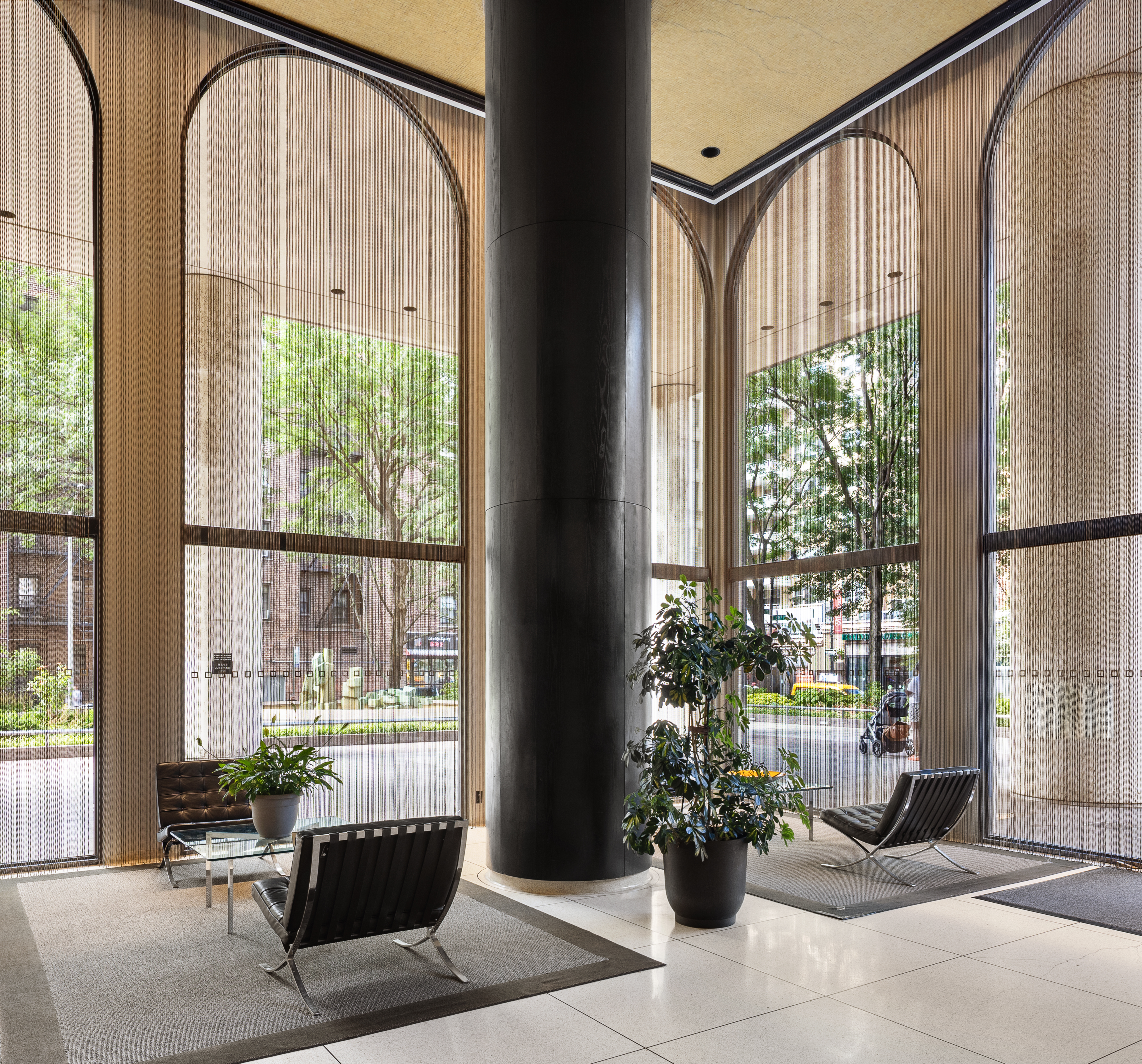 60 East 8th Street, Unit 20P Manhattan, NY 10003 - Photo 8 of 11 a living room filled with furniture and a potted plant