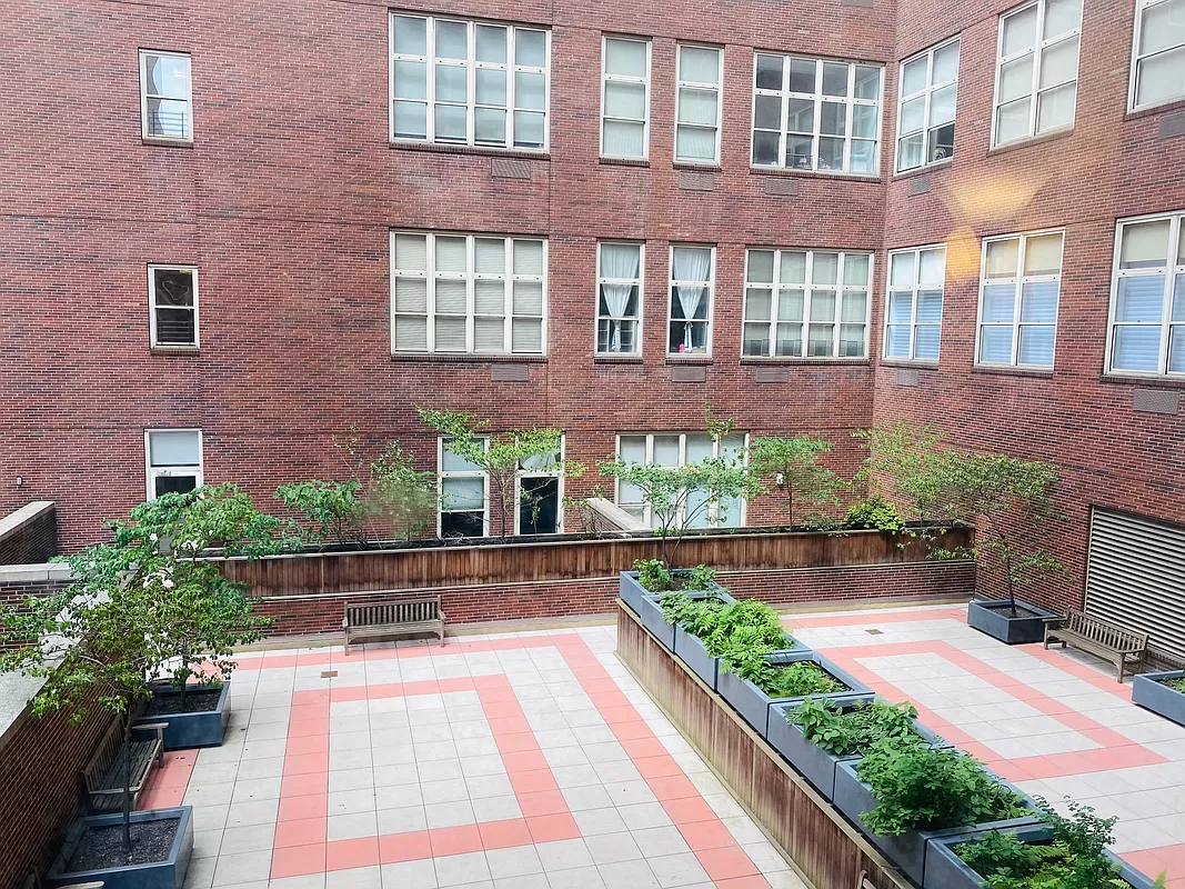 120 East 87th Street, Unit R6L Manhattan, NY 10028 - Photo 15 of 19 a front view of a house with a yard