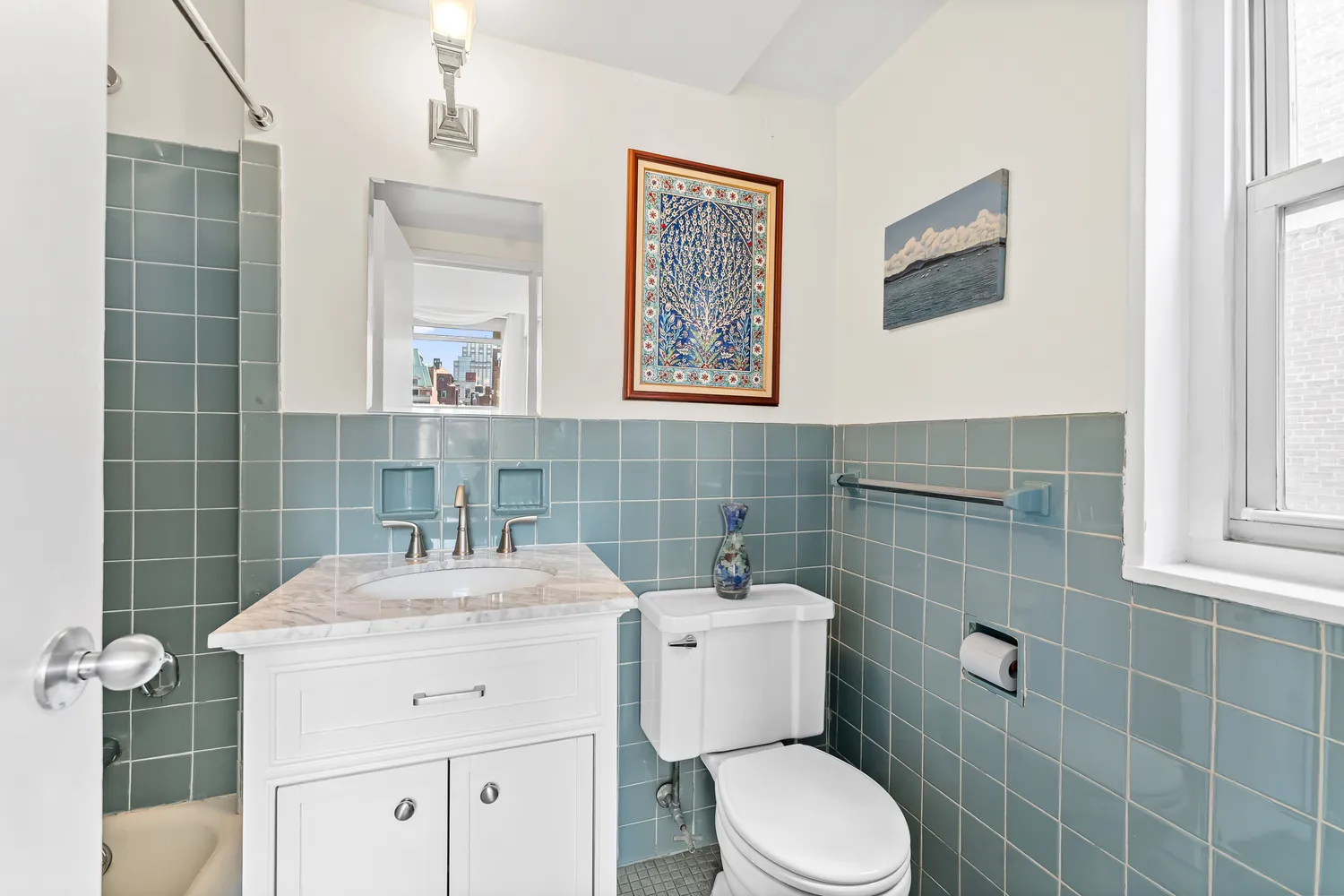 a bathroom with a toilet sink and mirror