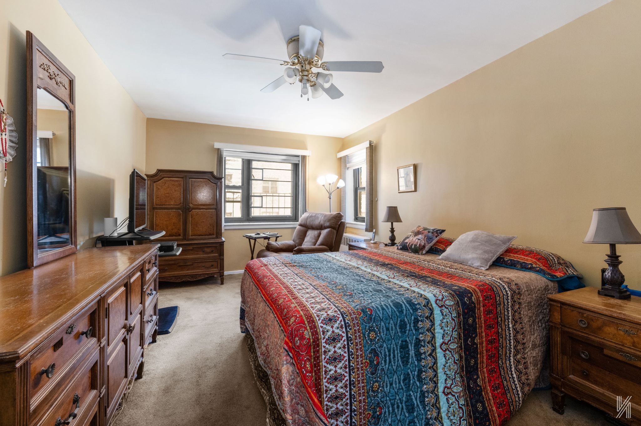 34-10 94th Street, Unit 3D Queens, NY 11372 - Photo 12 of 17 a bed room with bed and a flat tv screen on a dresser