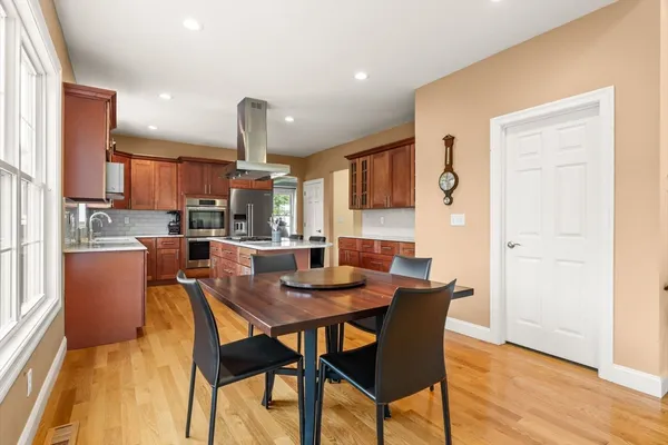 a dining room with furniture and wooden floor