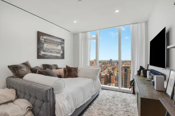 a bedroom with furniture and a flat screen tv