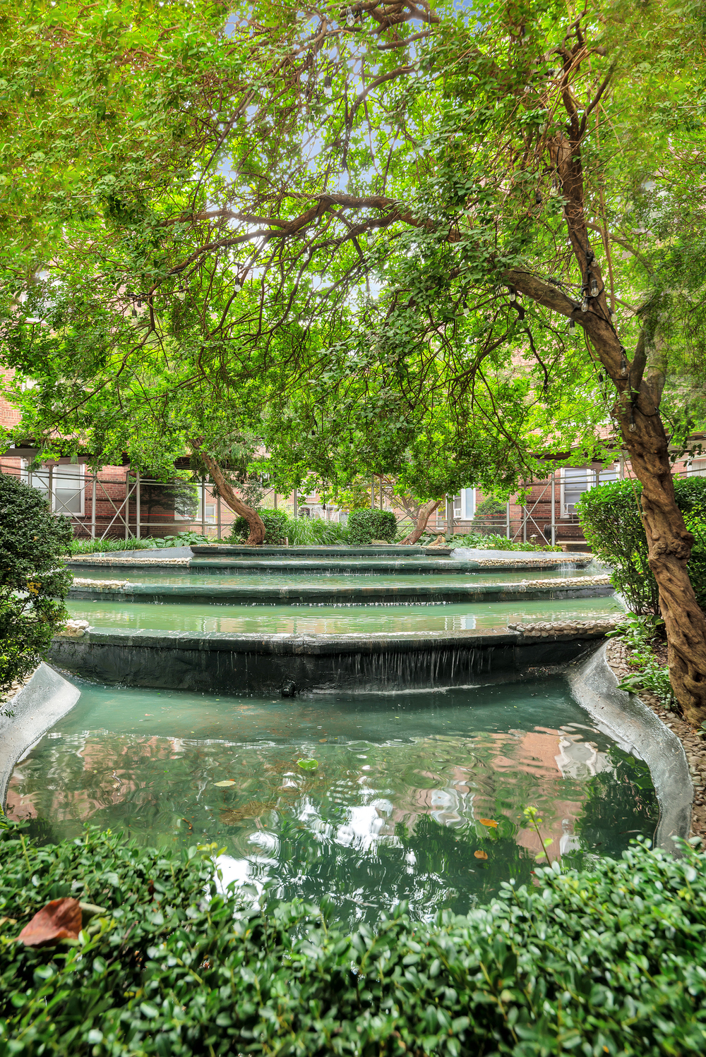 73-12 35th Avenue, Unit A62 Queens, NY 11372 - Photo 8 of 10 a backyard of a house with a table and chairs