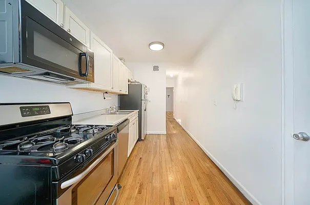 103 West 105th Street, Unit 2B Manhattan, NY 10025 - Photo 9 of 9 a kitchen with a stove and a microwave