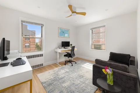 a living room with furniture fireplace and a window