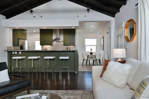 a kitchen with a table chairs and a refrigerator