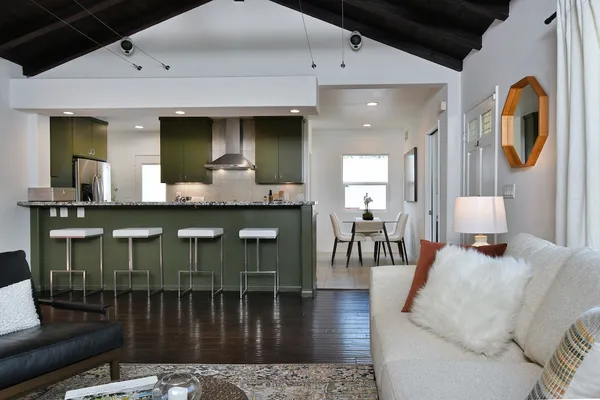a kitchen with a table chairs and a refrigerator