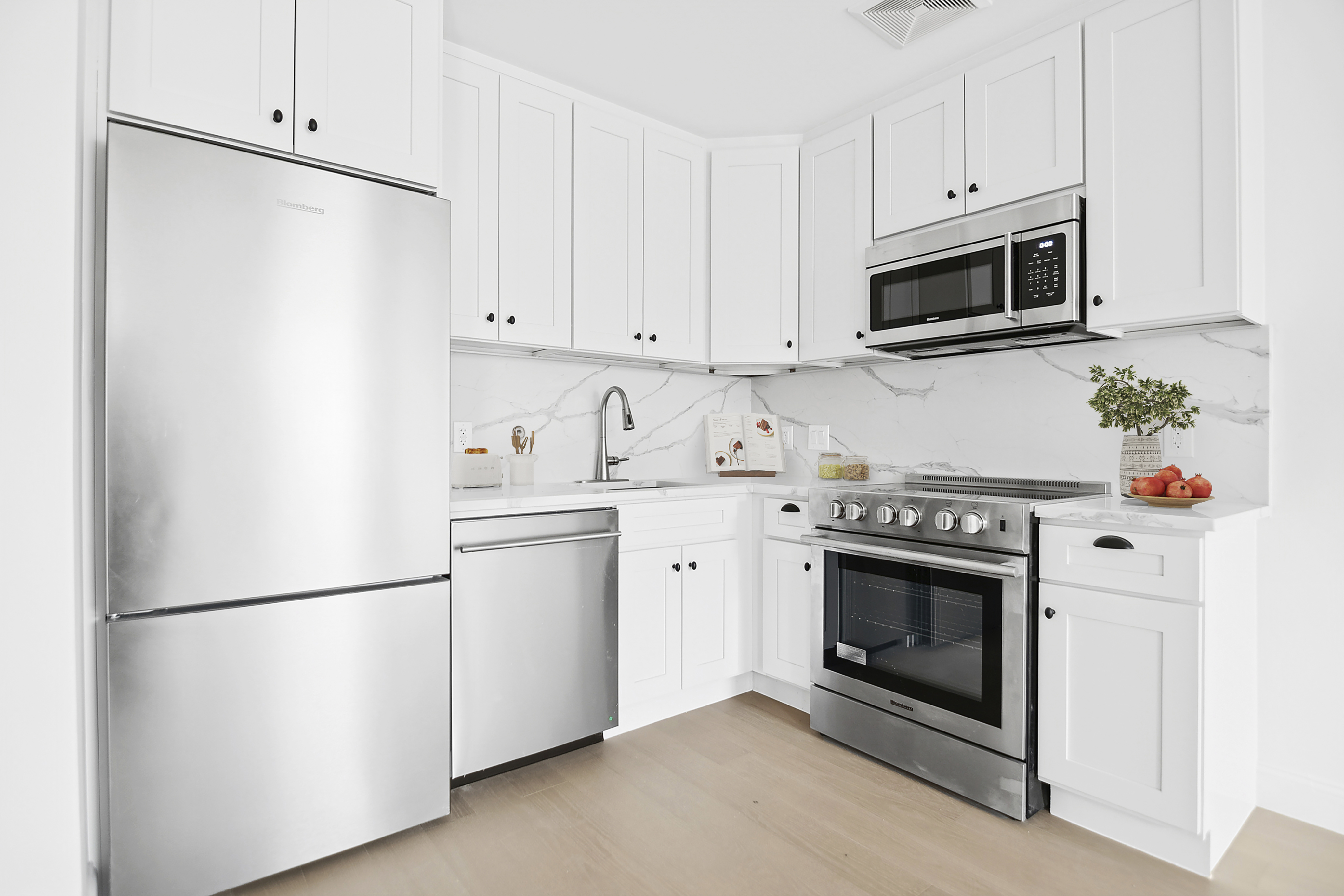 298 Degraw Street, Unit 2 Brooklyn, NY 11231 - Photo 4 of 11 a kitchen with stainless steel appliances white cabinets and a refrigerator