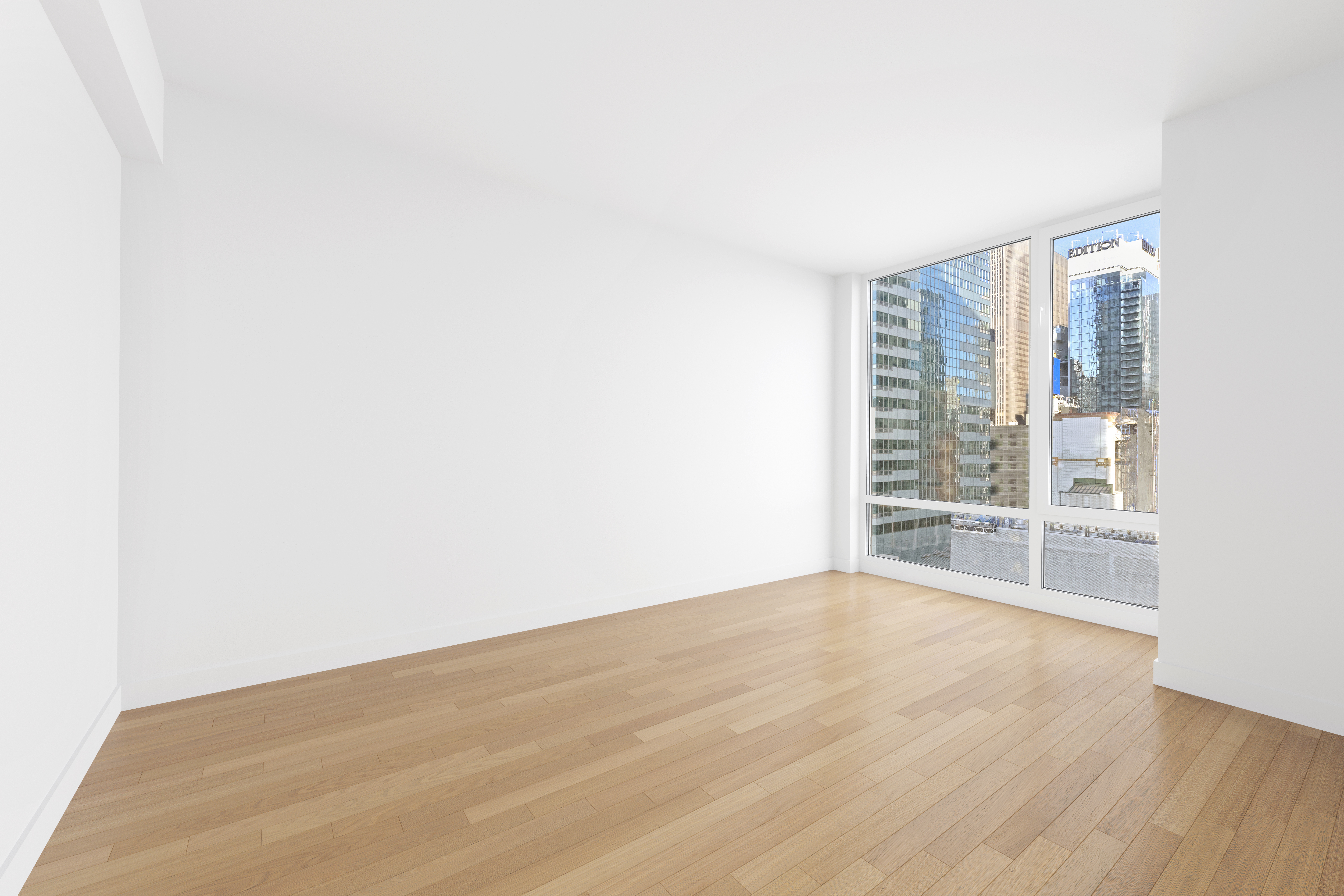 247 West 46th Street, Unit 2305 Manhattan, NY 10036 - Photo 7 of 13 a view of an empty room with wooden floor and a window