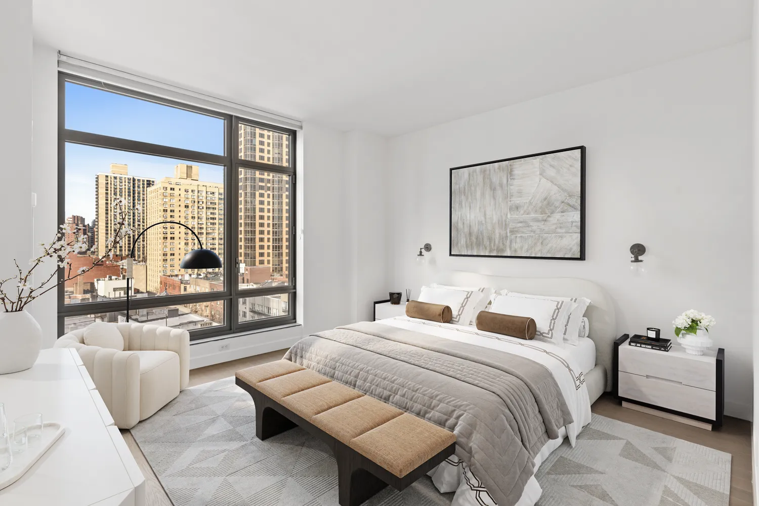 a bedroom with a bed couch and a large window