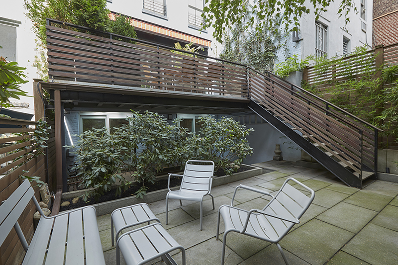 308 West 19th Street, Unit GARDEN Manhattan, NY 10011 - Photo 10 of 18 a view of an outdoor sitting area with wooden fence