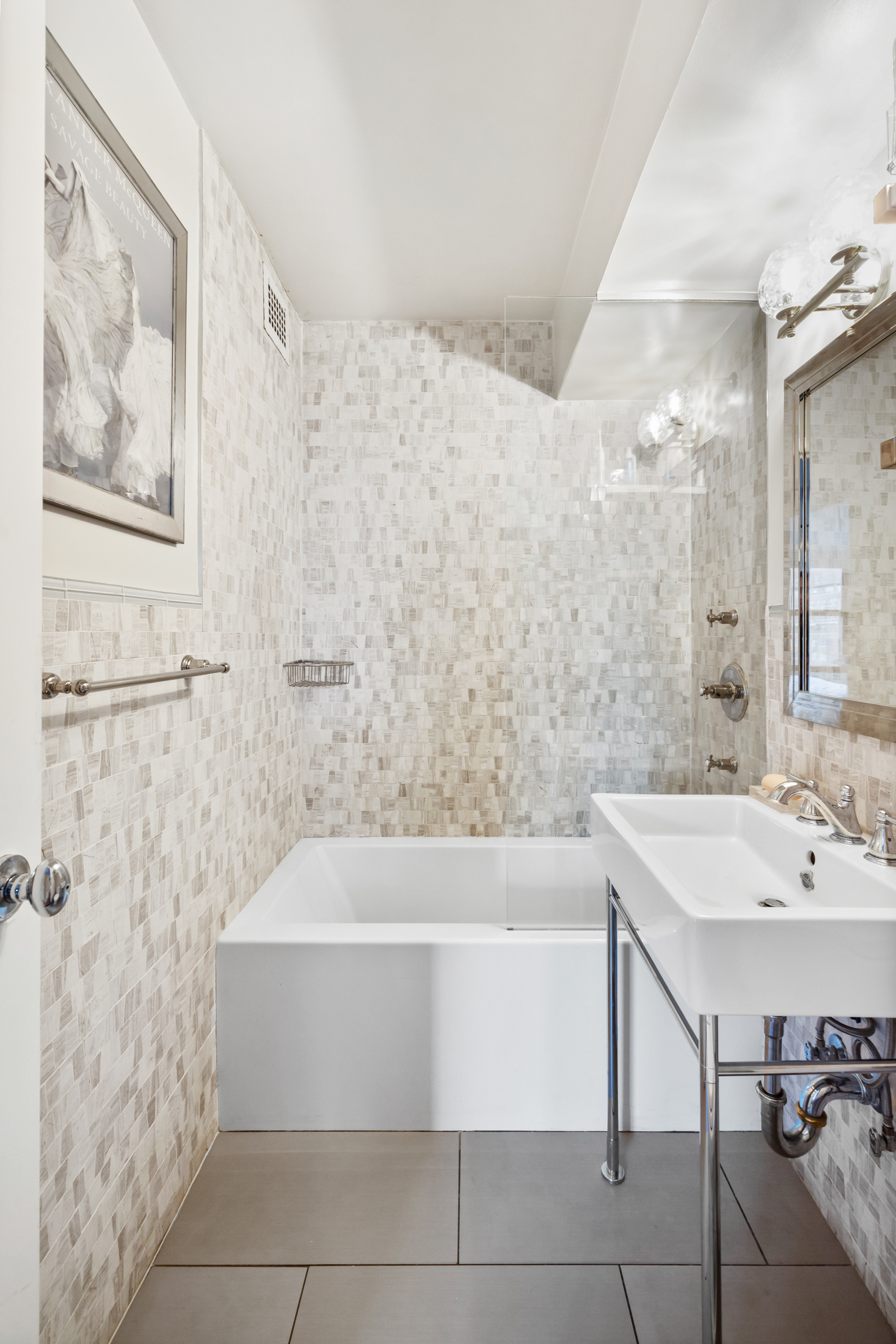 130 East 18th Street, Unit 14B Manhattan, NY 10003 - Photo 7 of 8 a bathroom with a bathtub and a sink