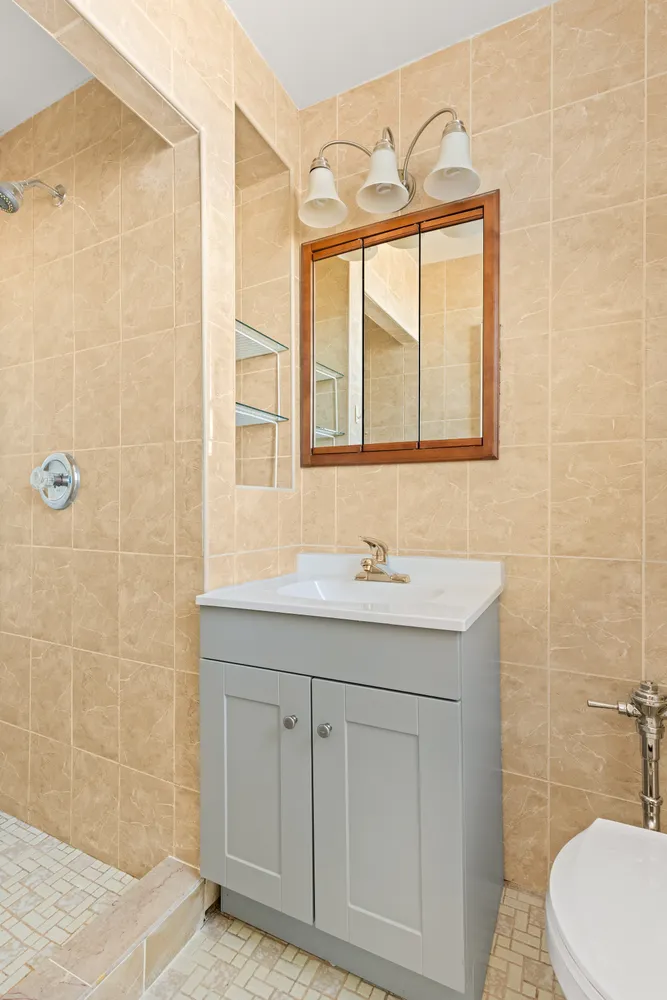 a bathroom with a sink a toilet and a shower