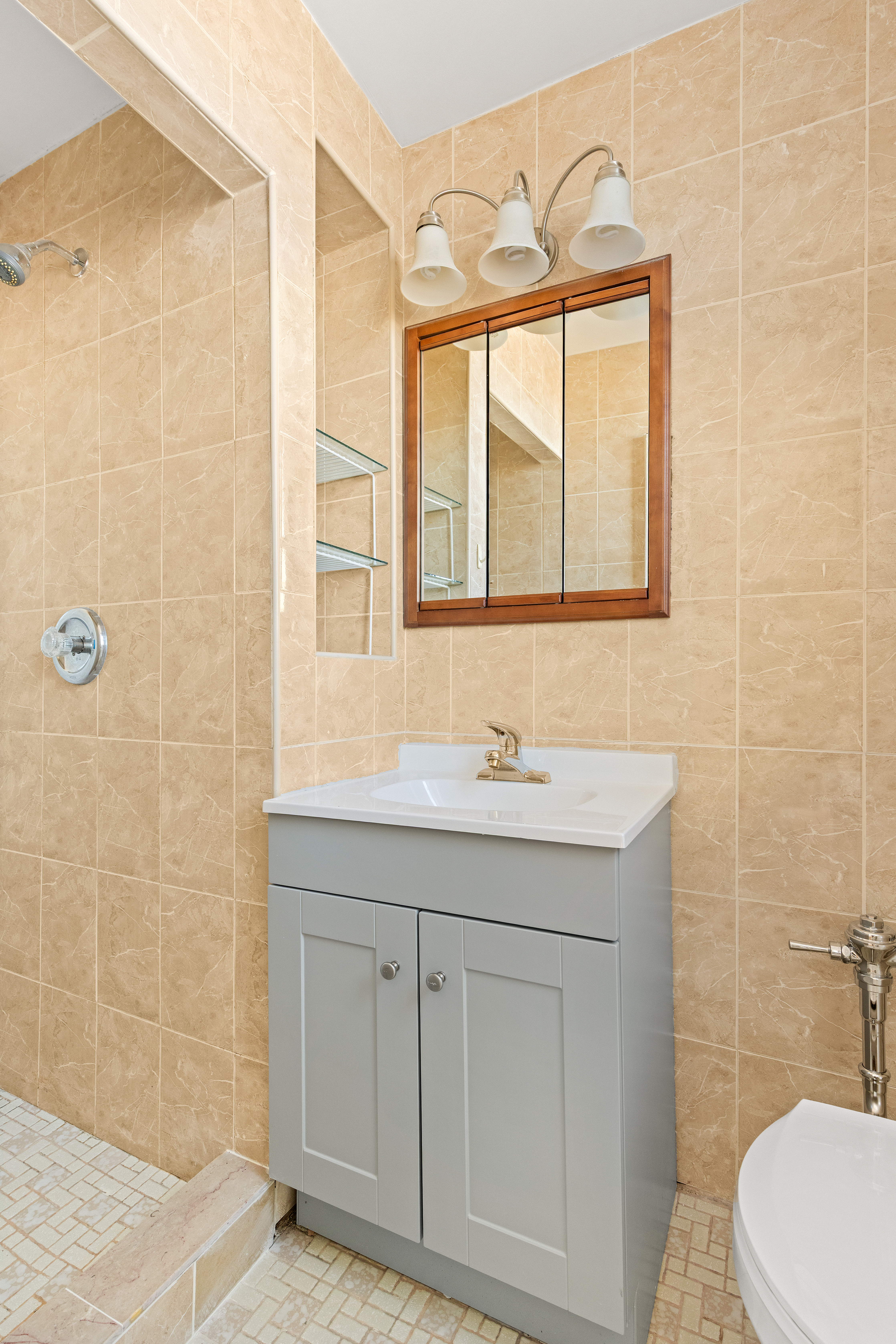 770 Ocean Parkway, Unit 6F Brooklyn, NY 11230 - Photo 16 of 17 a bathroom with a sink a toilet and a shower