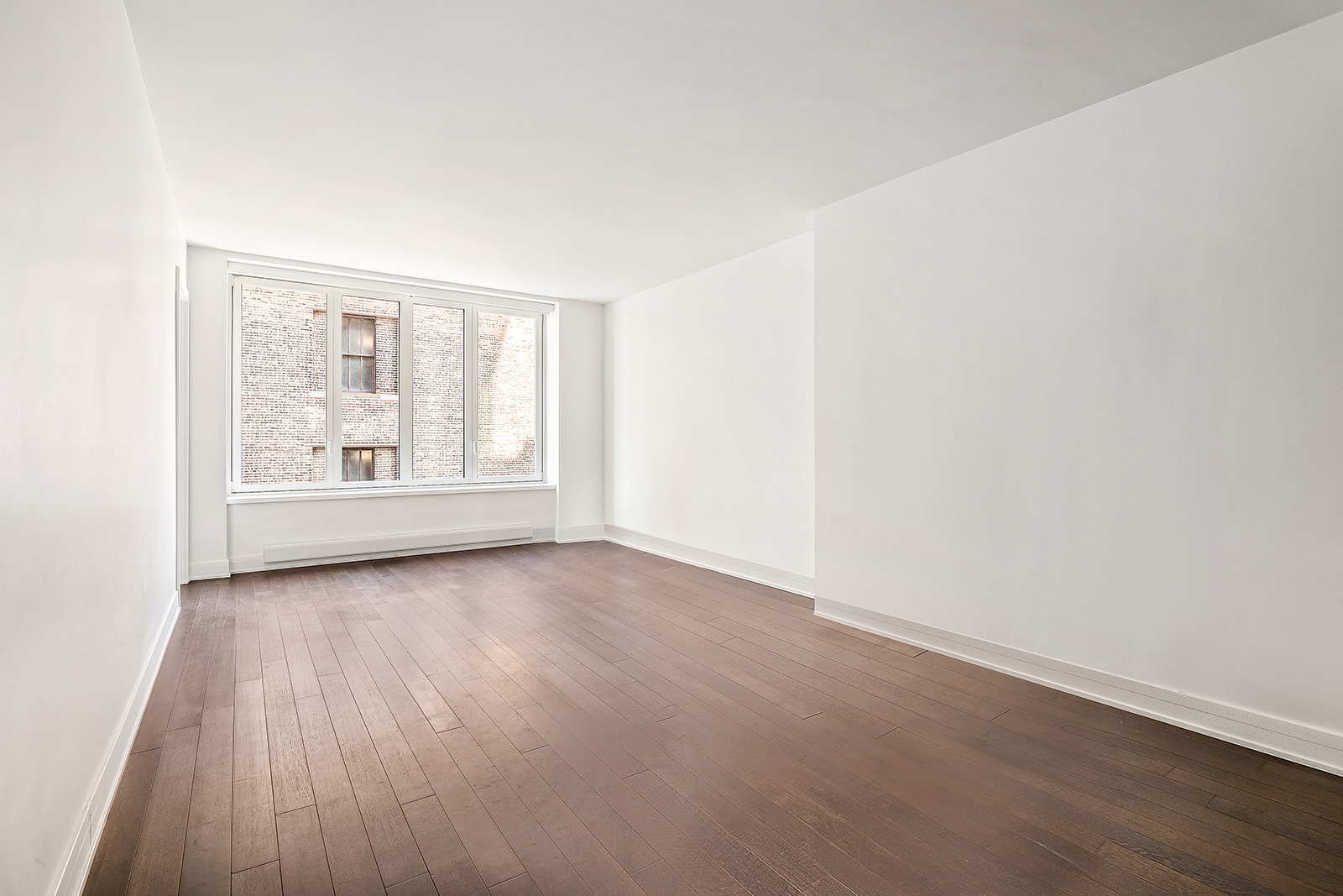 5 Franklin Place, Unit 14B Manhattan, NY 10013 - Photo 3 of 13 an empty room with wooden floor and windows