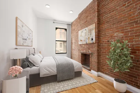 a bedroom with a bed and a fireplace