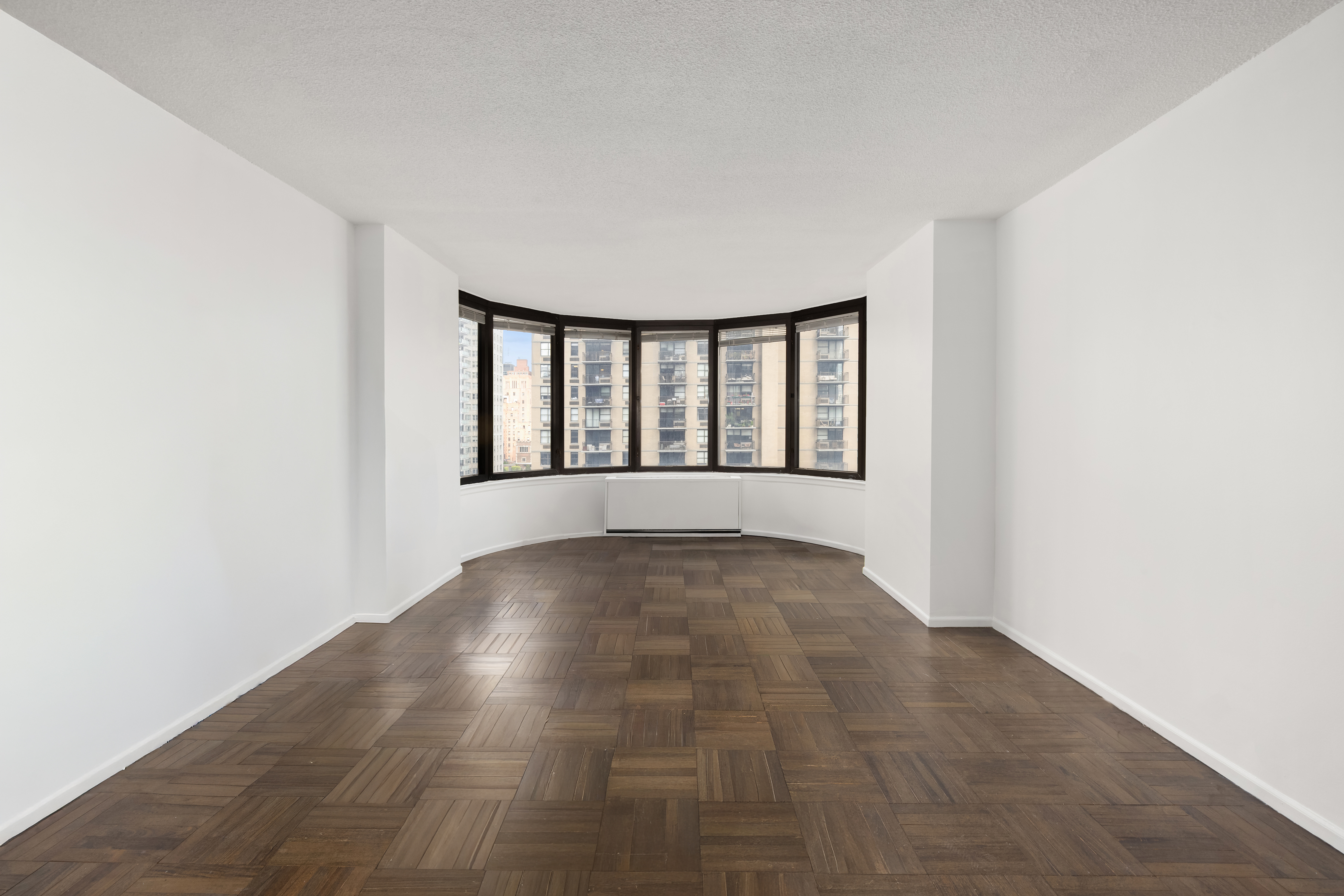 330 East 38th Street, Unit 22H Manhattan, NY 10016 - Photo 8 of 11 a view of an empty room with windows