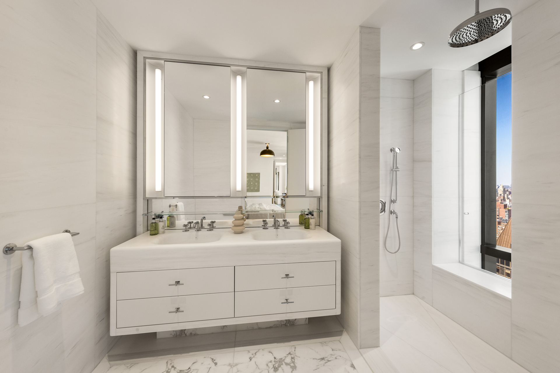 430 East 58th Street, Unit 38A Manhattan, NY 10022 - Photo 8 of 22 a bathroom with a double vanity sink mirror and double