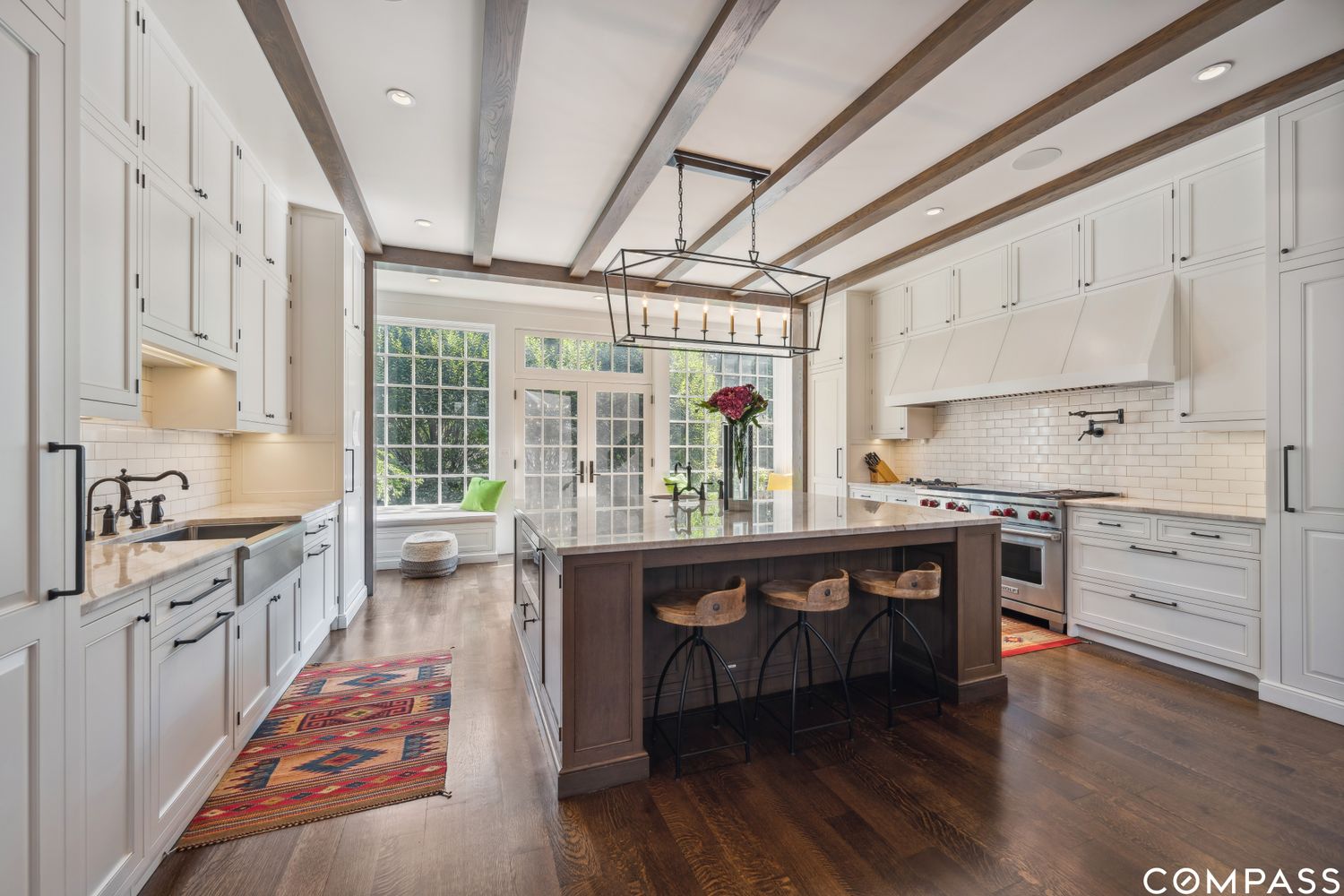 a open kitchen with stainless steel appliances granite countertop a stove and a wooden floors