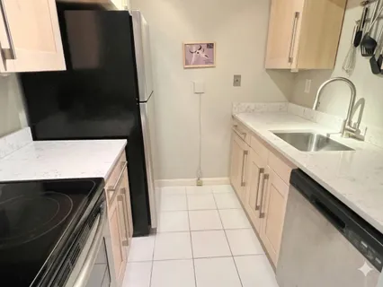 a kitchen with a sink and a stove top oven