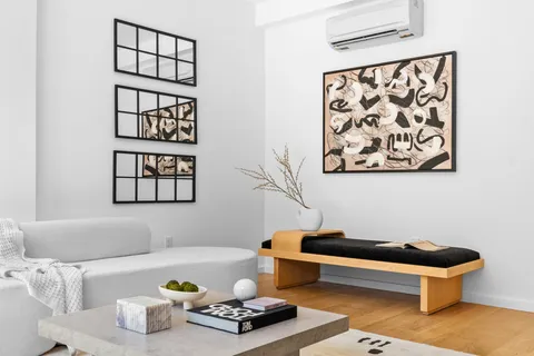 a living room with furniture and wall paintings