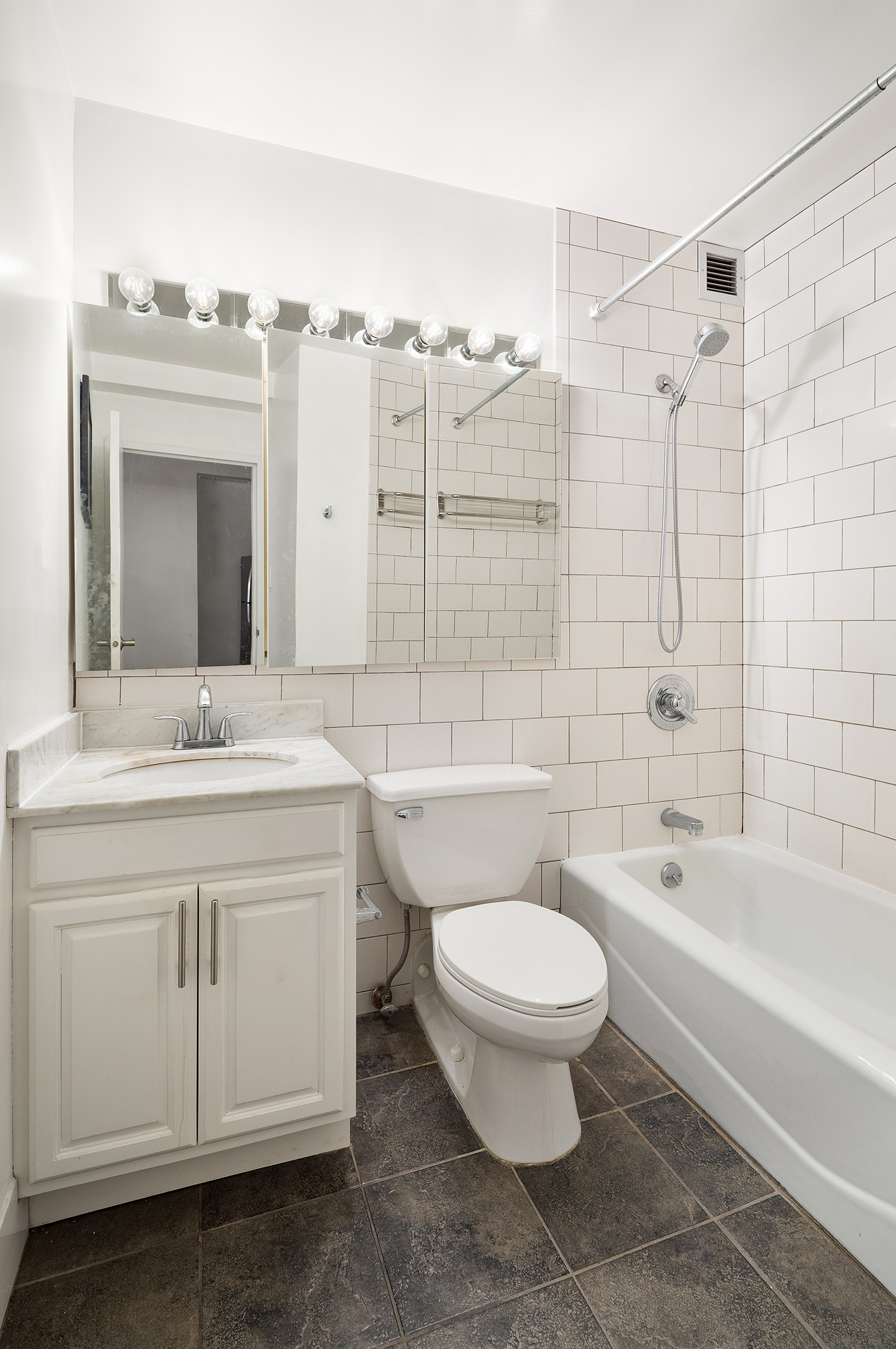 350 West 14th Street, Unit 7E Manhattan, NY 10014 - Photo 5 of 5 a bathroom with a granite countertop toilet a sink and a bathtub